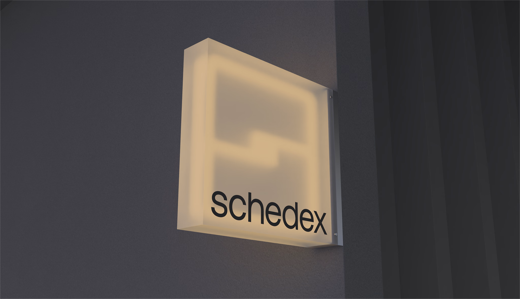 The Schedex sign, lit on a wall